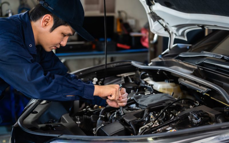 male-mechanic-using-wrench-repair-engine-car-service (1)